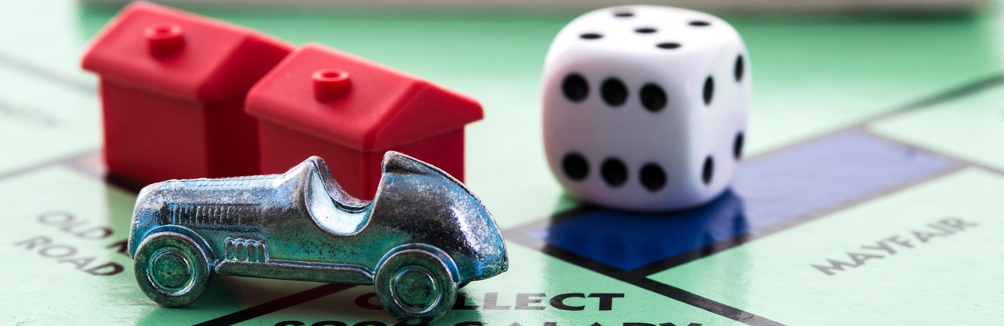 monopoly gameboard with hotels and car